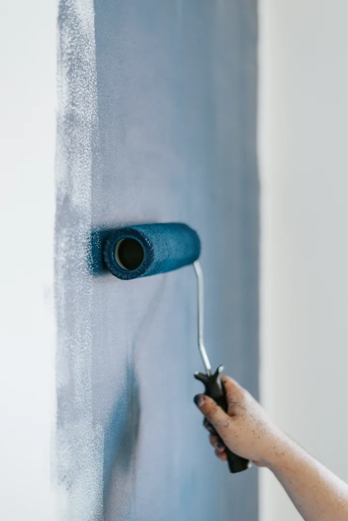 closeup-shot-female-using-paint-rollers