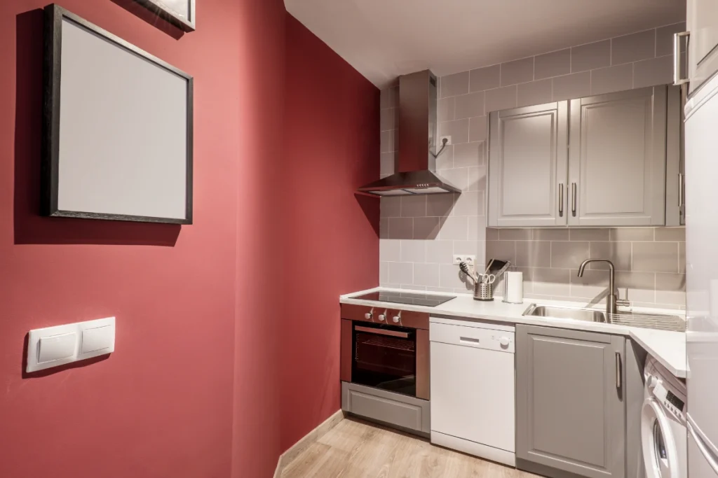 Repainted kitchen using bold red and soft grey tones